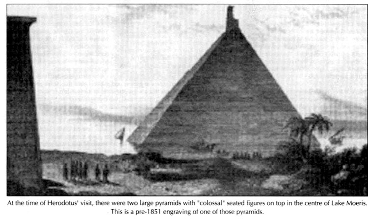 at the time of herodotus visit, there were two large pyramids with colossal seated figures on top in the center of lake moeris